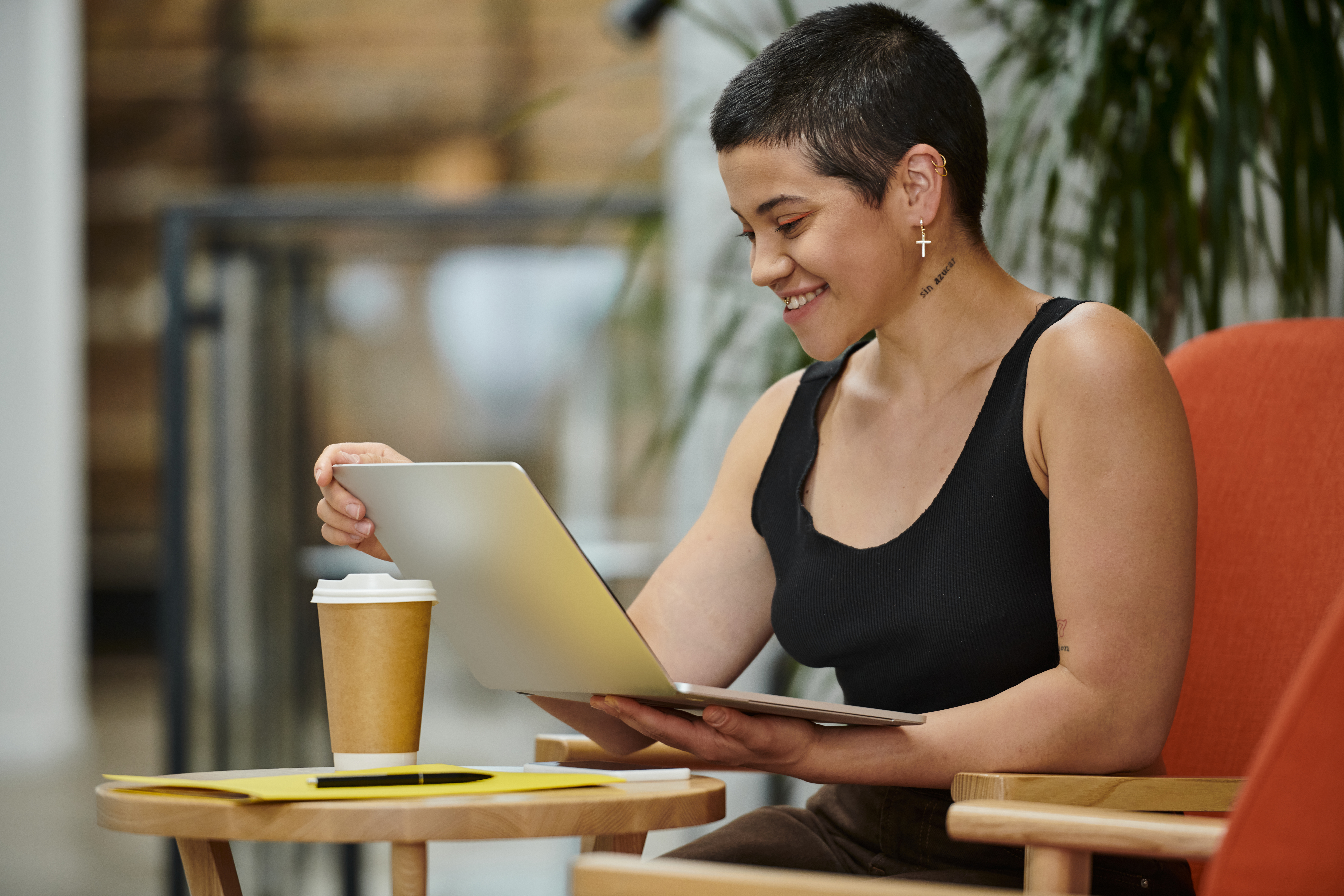tattoo: no sugar, cheerful woman using laptop, video call, working on startup project, coworking