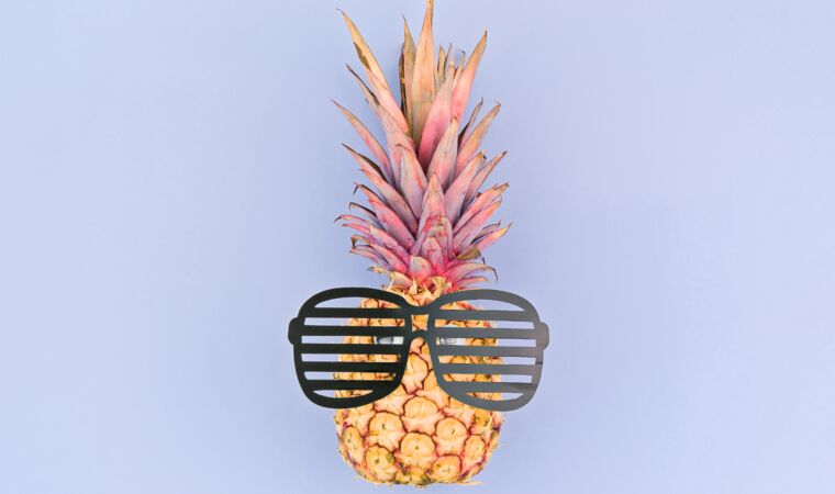 Yellow pineapple face with glasses on purple background. Back to school or sale stationery concept